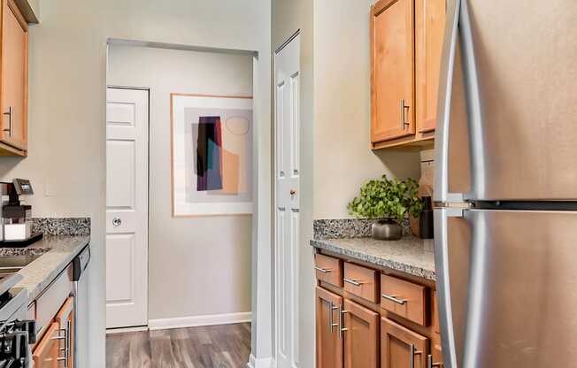 a kitchen with wood cabinets and stainless steel appliances