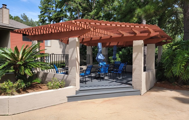 a covered patio with chairs and a pergola