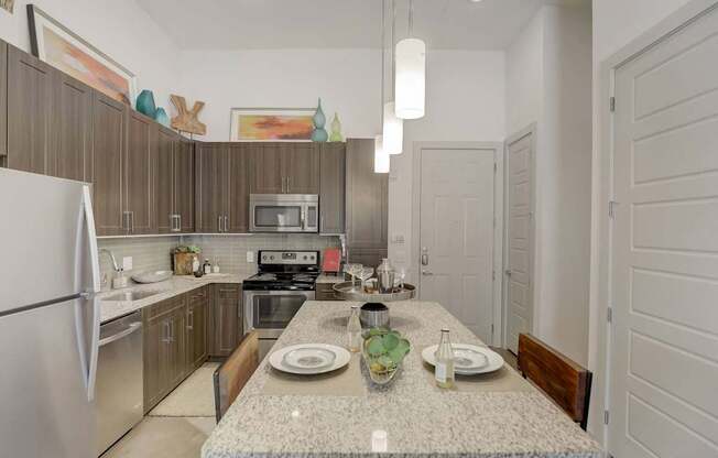 A kitchen with a table set for two at Infinity on the Point Apartments, Dallas, Texas