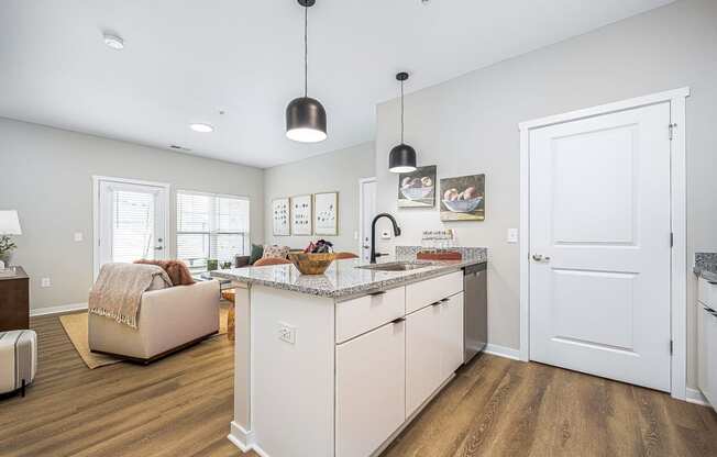 a kitchen with an island and a living room with a couch