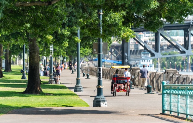 a man riding a horse drawn carriage down a sidewalk