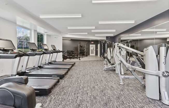 a gym with treadmills and other exercise equipment