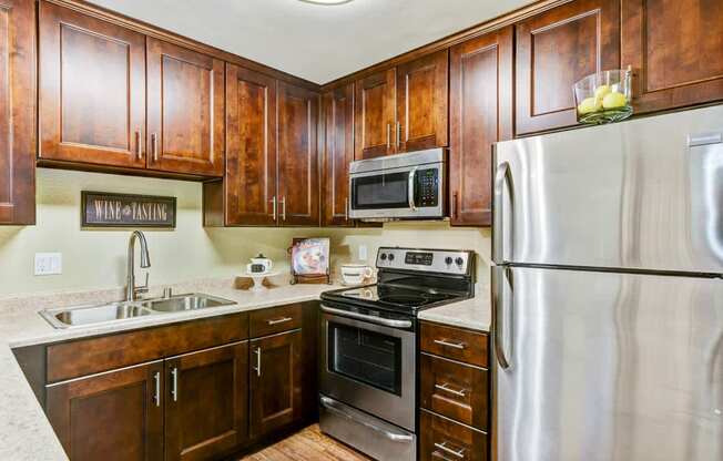 A kitchen with wooden cabinets and stainless steel appliances.