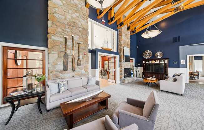 A living room with a stone wall and a fireplace.