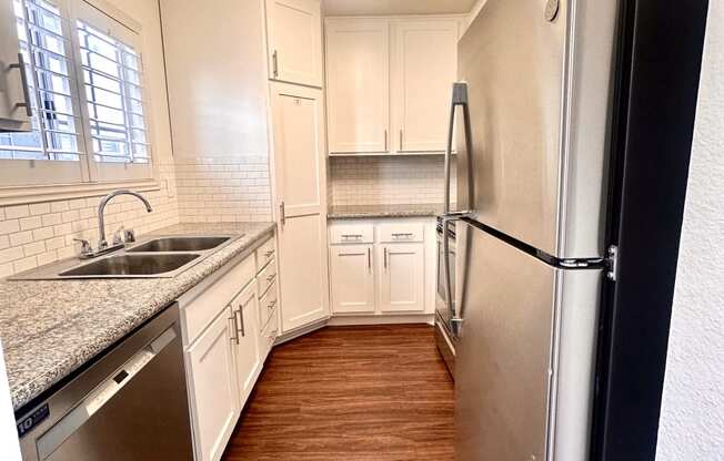 a kitchen with stainless steel appliances and white cabinets