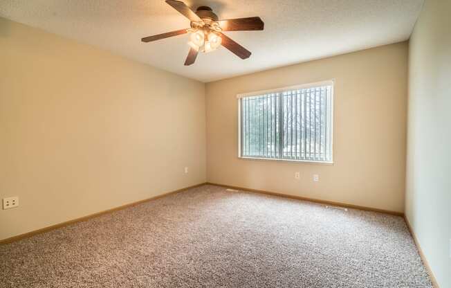 Large carpeted bedroom with window
