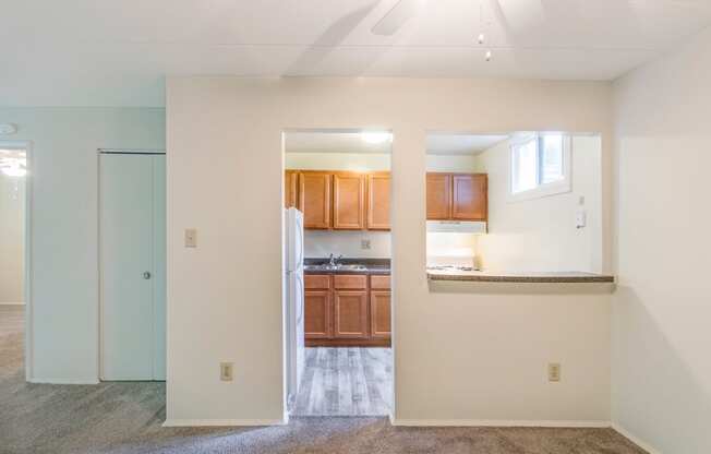 This is a photo of the kitchen from the dining room of the 550 square foot 1 bedroom, 1 bath patio apartment at College Woods Apartments in the North College Hill neighborhood of Cincinnati, OH.