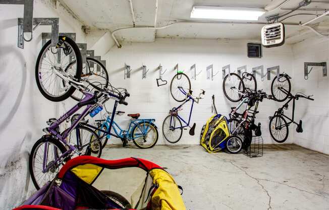 a group of bikes hanging on a wall in a garage