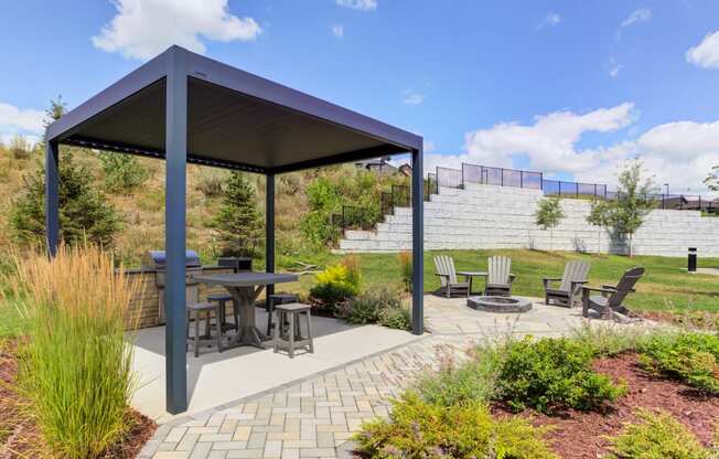 Grill pavilion with covered patio and firepit with Adirondack chairs
