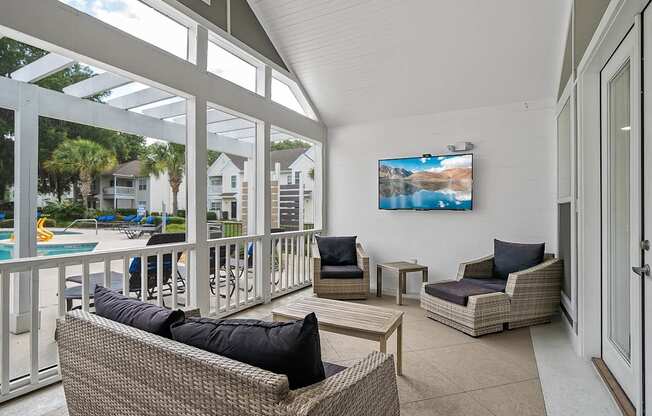A sunny day at the pool with a view of the backyards of houses.