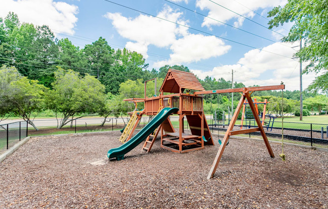 a playground with a swing set and a slide