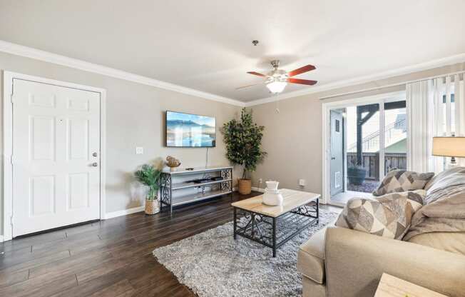 a living room with a couch and a ceiling fan