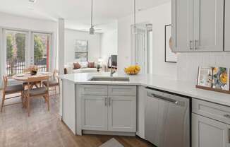 A kitchen with a table and chairs by a window.