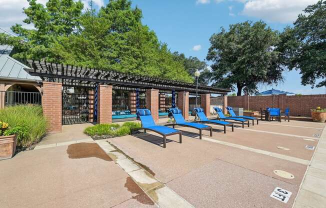 a group of blue lounge chairs in front of a building