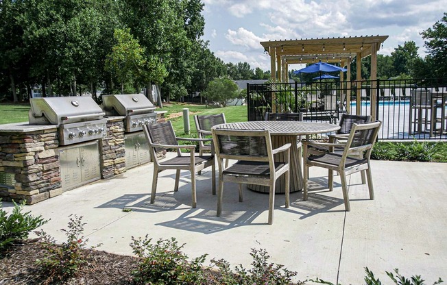 Grilling station with two grills and a table with chairs