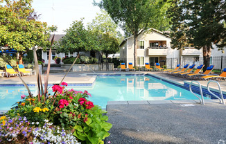 Fulton's Crossing and Landing Apartments  swimming pool with chairs and flowers around it