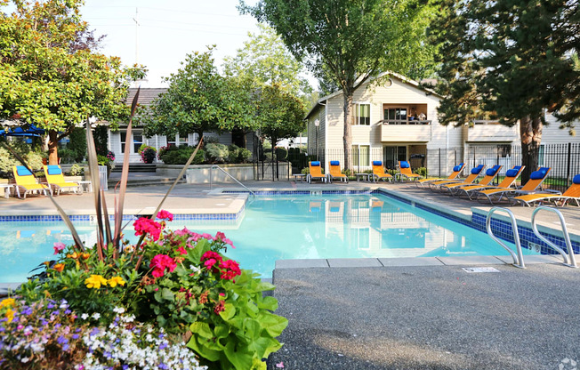 Fulton's Crossing and Landing Apartments  swimming pool with chairs and flowers around it