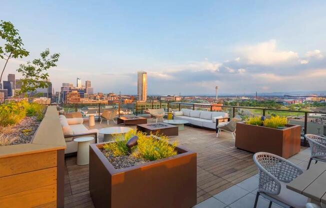 Rooftop deck with lush landscaping, fire pits, outdoor tv, plus city and mountain views.