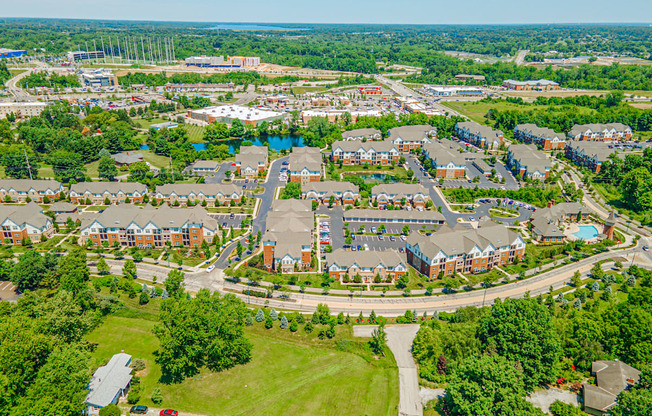 an aerial view of a neighborhood with houses and a road