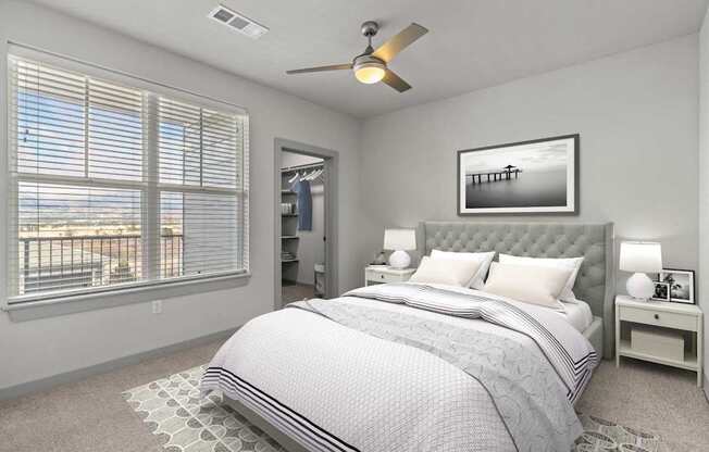 A bedroom with a large bed and a ceiling fan.