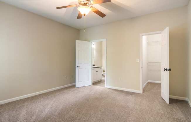 Model bedroom with private bathroom and walk-in closet at Angel Landing Apartment Homes in Pensacola, FL