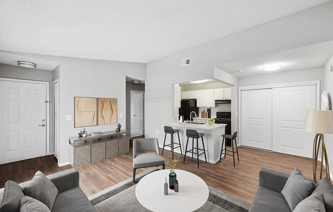 Model Living Room with Wood-Style Flooring and View of Kitchen at Vue at Baymeadows Apartments in Jacksonville, FL.