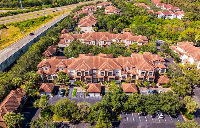 Aerial of residential buildings and parking area alongside highway access
