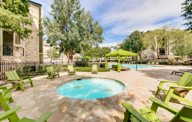 View of Pool Area, Showing Hot Tub, Outdoor Furniture, and Cabanas at Stonebriar of Frisco Apartments