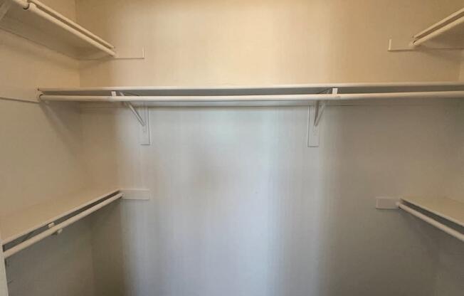 Empty white shelves in a room.