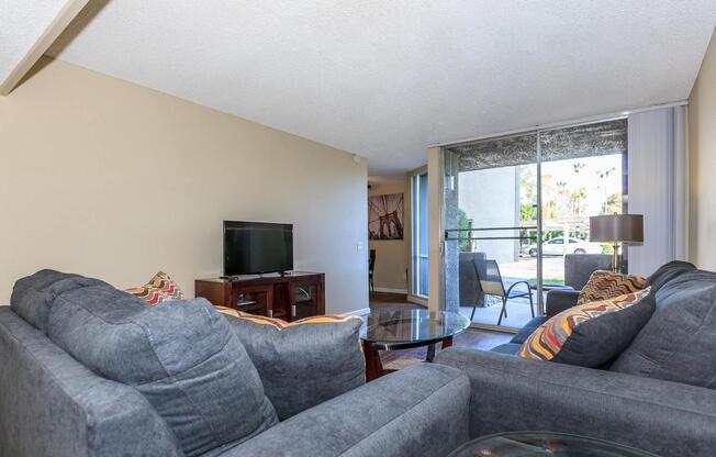 a living room filled with furniture and a flat screen tv