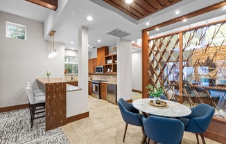 a dining room and kitchen with a table and chairs