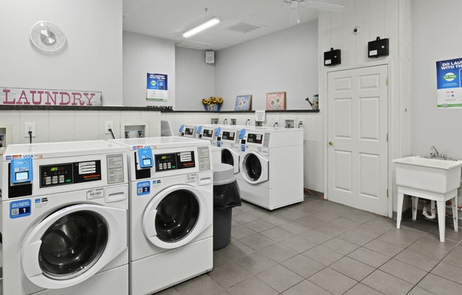 a washer and dryer room with a bunch of washing machines
