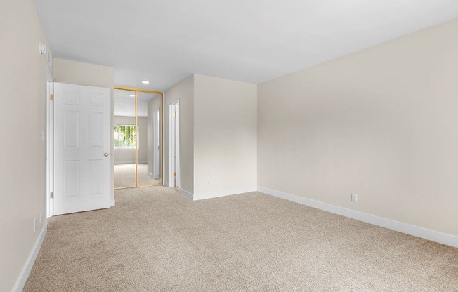 A room with a carpeted floor and white walls.