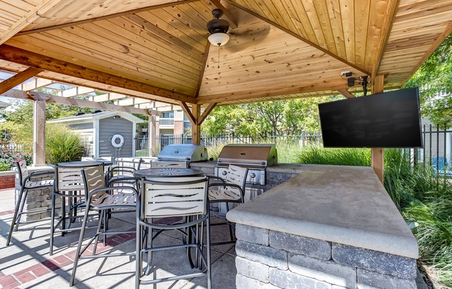 Covered seating pavillion with grill and flat screen tv