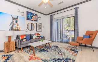 a living room with a couch and a table and a window