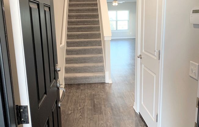 B2 (2-car) Entry with laminate wood flooring looking toward staircase