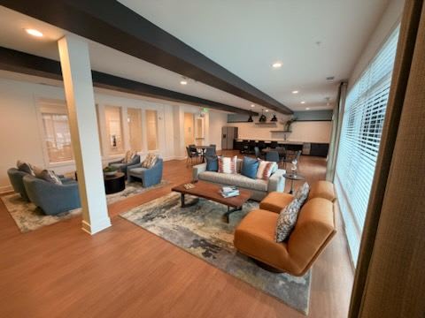 A modern living room with a large window and a wooden floor.