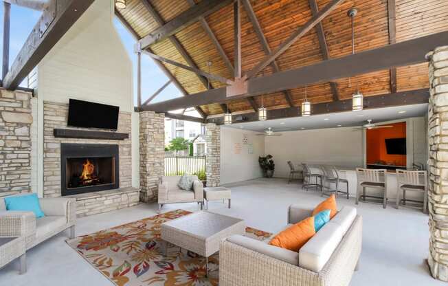 Copperfield apartments outdoor covered living area with fireplace and comfortable seating