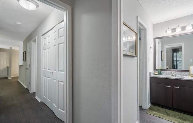 A bathroom with a vanity and a mirror.