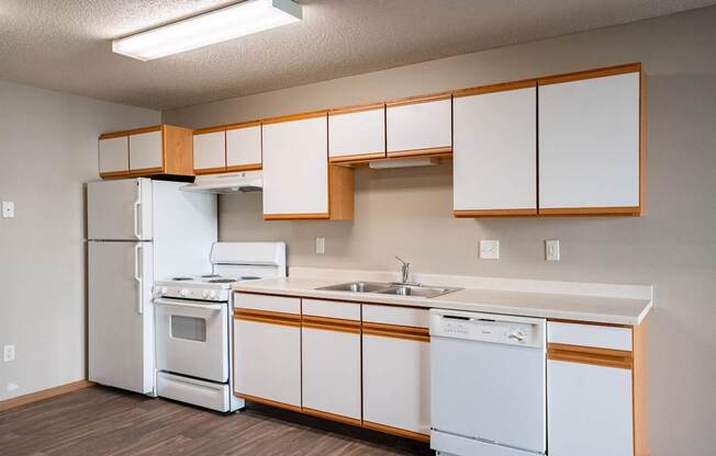 a kitchen with white appliances and white cabinets and a white refrigerator