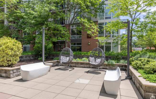 two urinals and two chairs on a patio