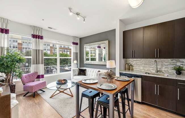 A modern kitchen with a dining table and chairs.