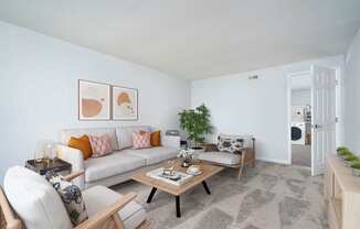 A living room with a white couch and a coffee table.at Camden Place, Dublin, OH