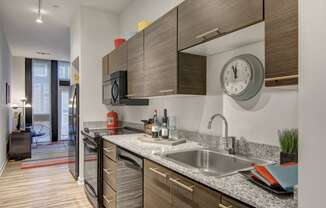 a kitchen with wood cabinets and granite countertops