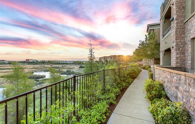 sunset and blue skyline along apartment exteriors