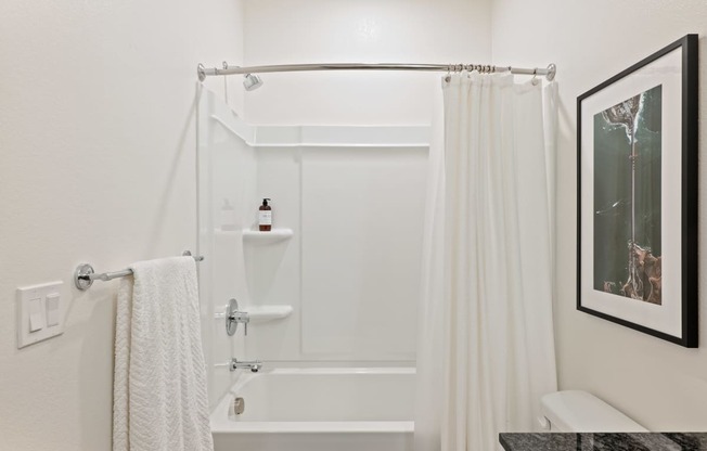 a bathroom with a shower and a sink and a shower curtain