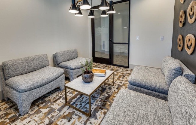 A living room with grey couches and a coffee table.