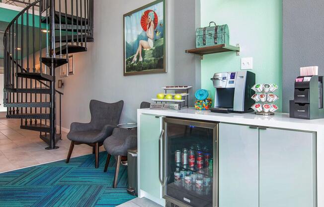 a hotel room with a counter with drinks and a spiral staircase