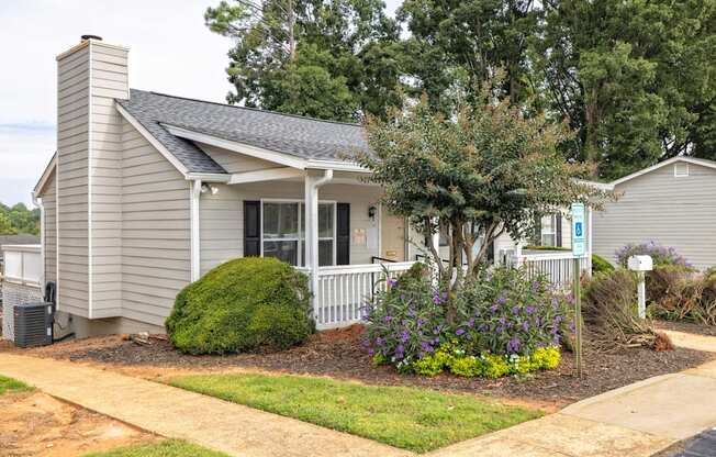 A small house with a well-kept front yard.