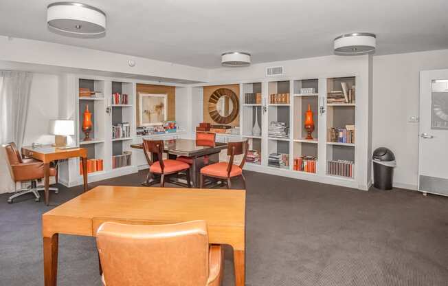 a club house with tables and chairs and bookshelves